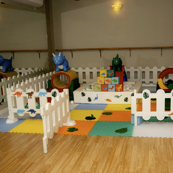 colorful baby playpen dinosaur theme in primary colors near mirror wall
