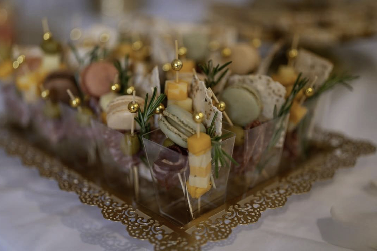 small food appetizers with cheese and meet pinwheels on gold plate