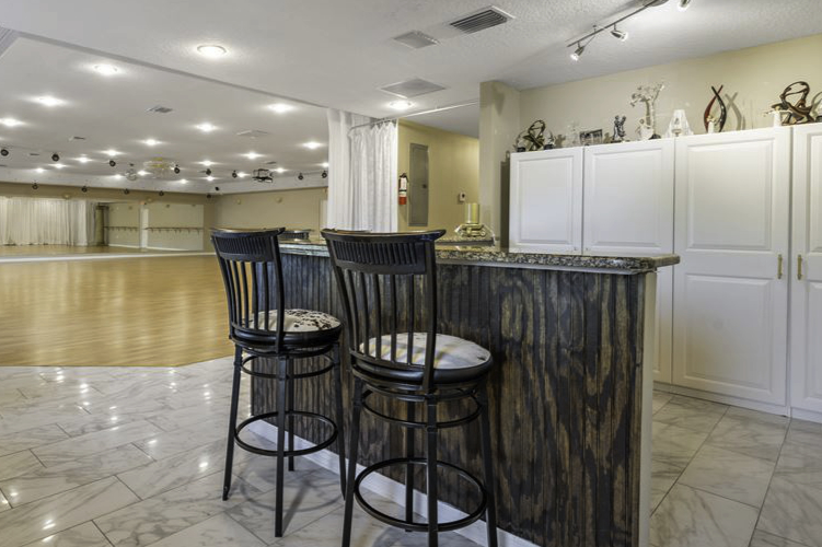 bar area with wood veneer and high bar stools included