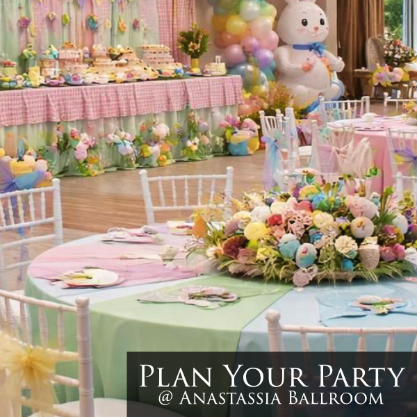buffet table with grassy pink tones, balloon tower, white bunny, and egg centerpieces with kaleidoscope colorful tablecloth